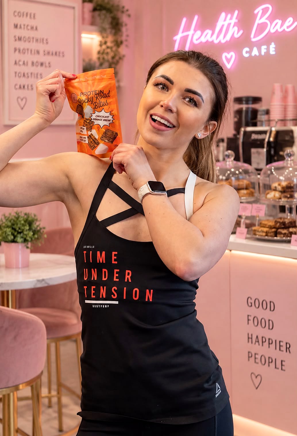 Health Bae founder holding Chocolate Orange Dream bites in the Health Bae Café